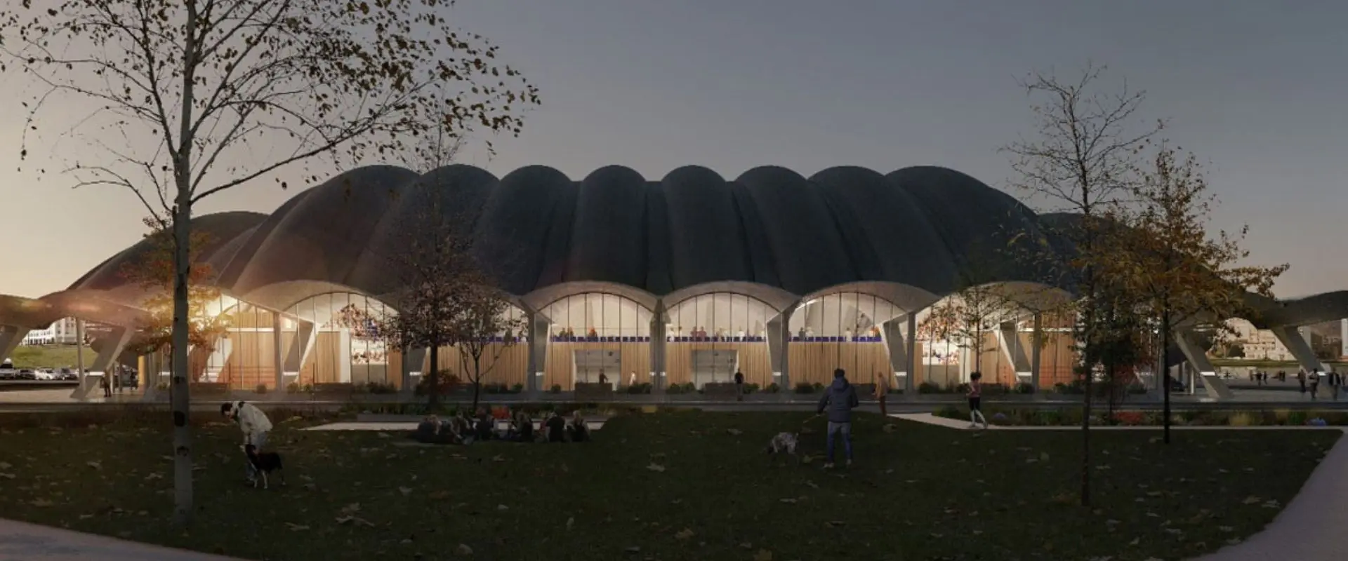 Exterior del edificio al atardecer destacando la cubierta en forma de caparazón de tortuga y la fachada acristalada