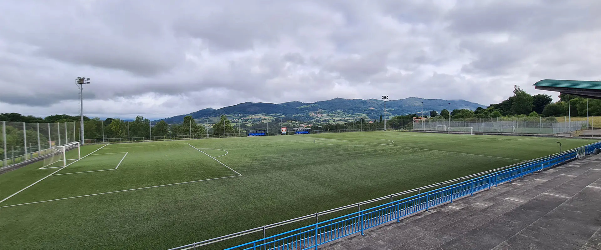 Panorámica del campo de juego desde las gradas, con vista de las porterías y torres de iluminación al fondo