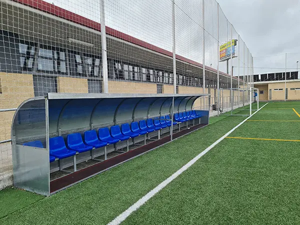 Perfil banquillo de suplentes con cubierta metálica y asientos azules para los jugadores y el equipo técnico